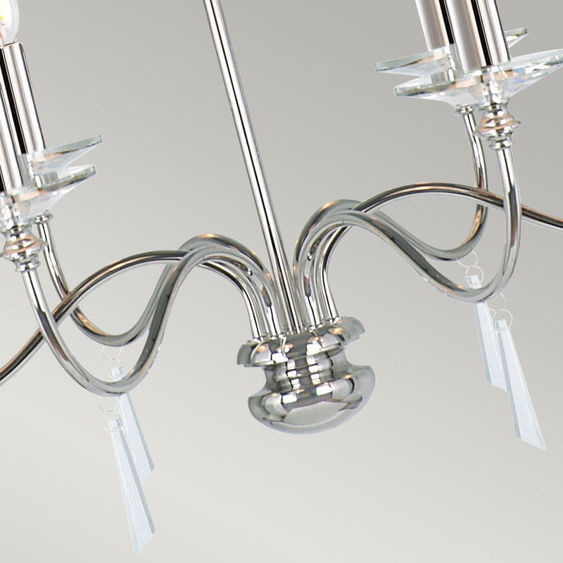 The Elstead Finsbury Park six-light chandelier finished in polished nickel, is a stunning traditional chandelier, with graceful upswept curved arms. Heavy-cut clear glass sconces, hand-cut glass drops, and matching candle tubes complete this classic light fitting. 