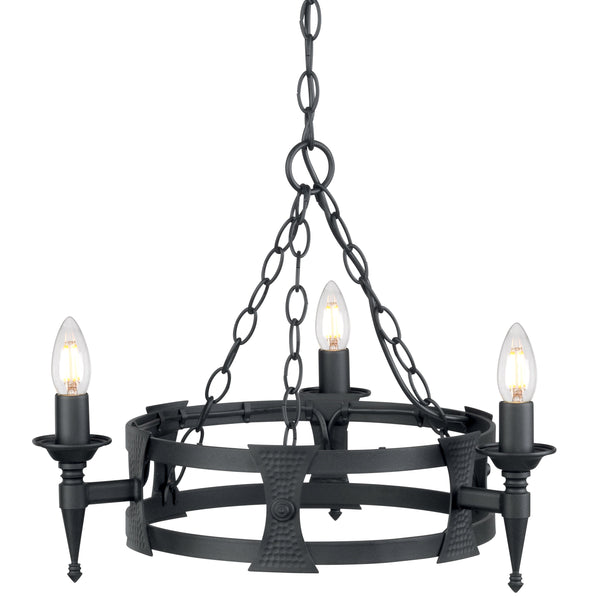 This Elstead Saxon matt black wrought iron 3 light cartwheel chandelier has two metal bands for the cartwheel rim, with hand-crafted beaten shields decorating the outer rim. Each of the three torchière light arms is mounted on a shield and features tapered finials and forged metal candle pans. It is all suspended from three chains attached to a central chain hanging from a circular ceiling mount.