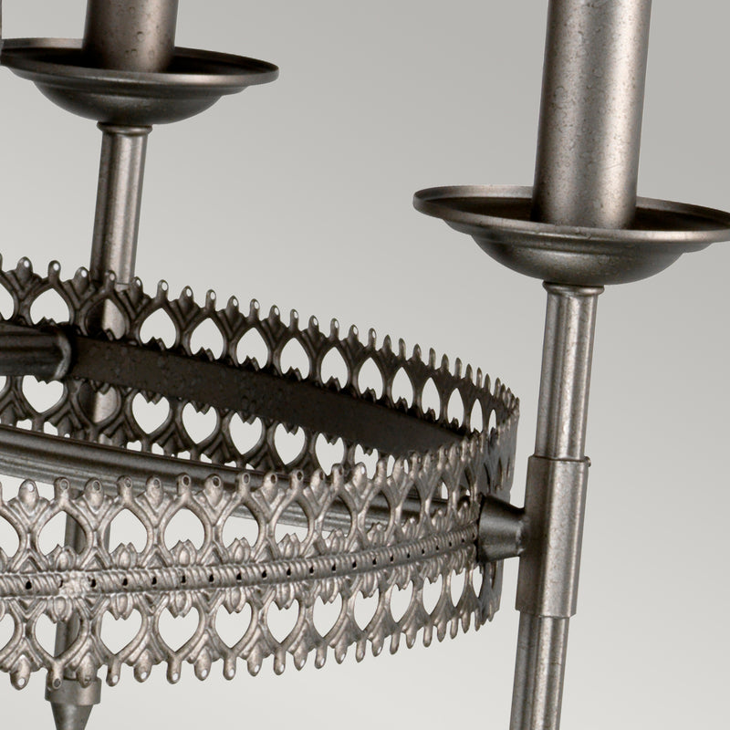 This Elstead Crown 9 light chandelier ceiling light in iron gate finish is traditional and rustic. Featuring a ceiling mount, chain suspension, and central rod, with a large two-tier frame formed by two filigree metalwork circles and curving arms.